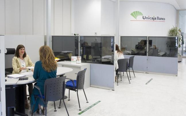 Una empleada de una sucursal bancaria atiende a una clienta en una imagen de archivo.