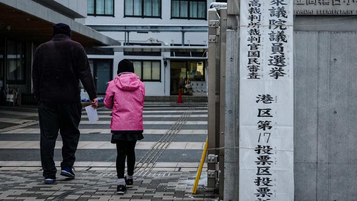 Dos personas acuden a votar en las elecciones de Japón.