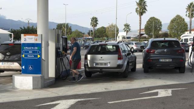 Un hombre repostando gasolina en una estación de servicio.