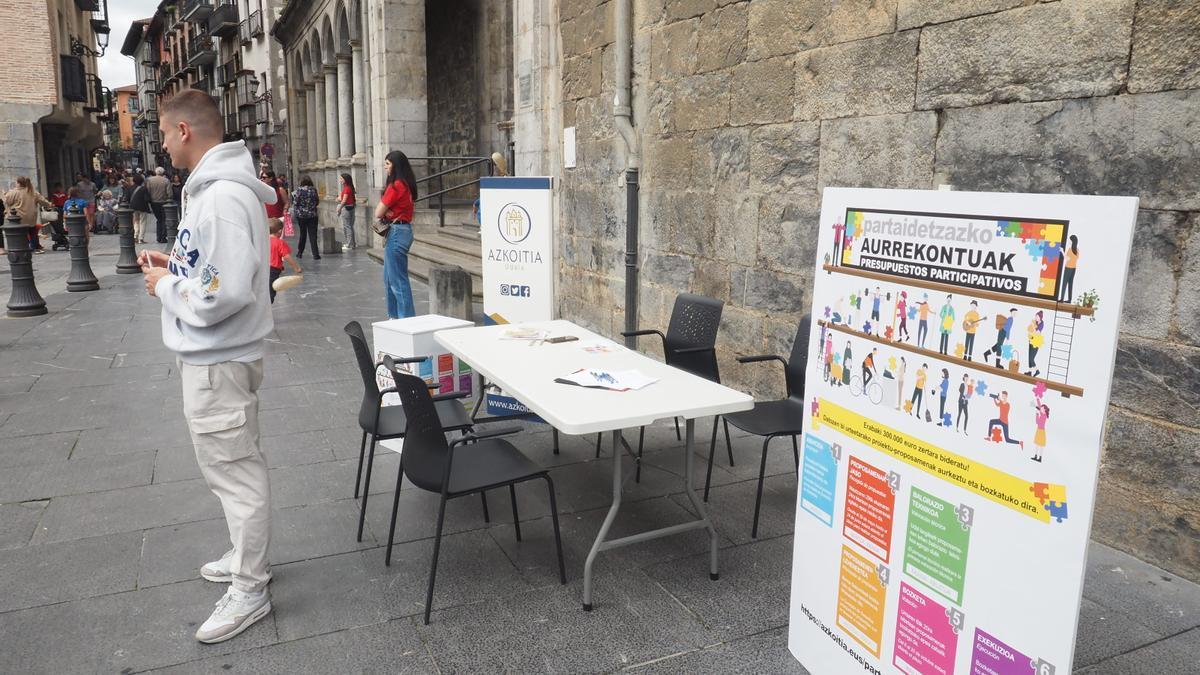 Mesa informativa sobre los presupuestos participativos instalada junto a la parroquia de Azkoitia