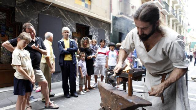 Un herrero trabajando a la antigua usanza en un mercado de los Burgos anterior.