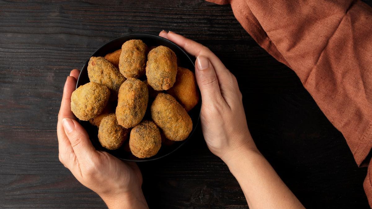 Un bol lleno de croquetas recién hechas sale a la mesa.