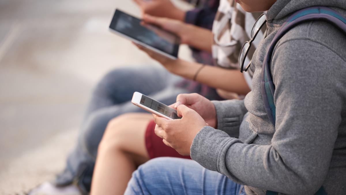 Menores con teléfonos móviles.