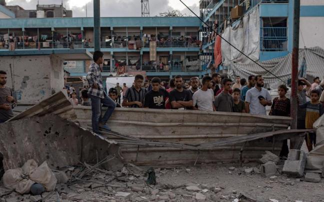 Palestinos observan los destrozos causados por un ataque israelí a la escuela de Al Jaouni este verano.