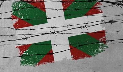 Ikurriña tras alambre de espino, símbolo de represión jeltzale
