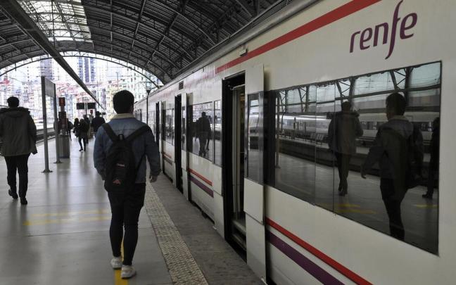 Varios usuarios junto a un tren de Cercanías Renfe en la estación de Abando de Bilbao Oskar González
